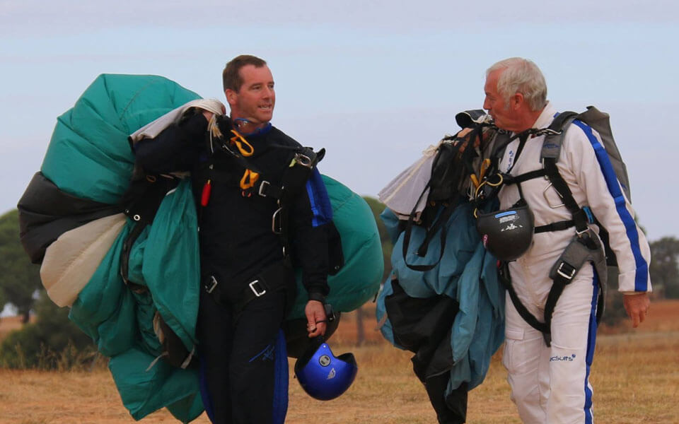 A nice photo of instructor and student after just landing their parachutes.